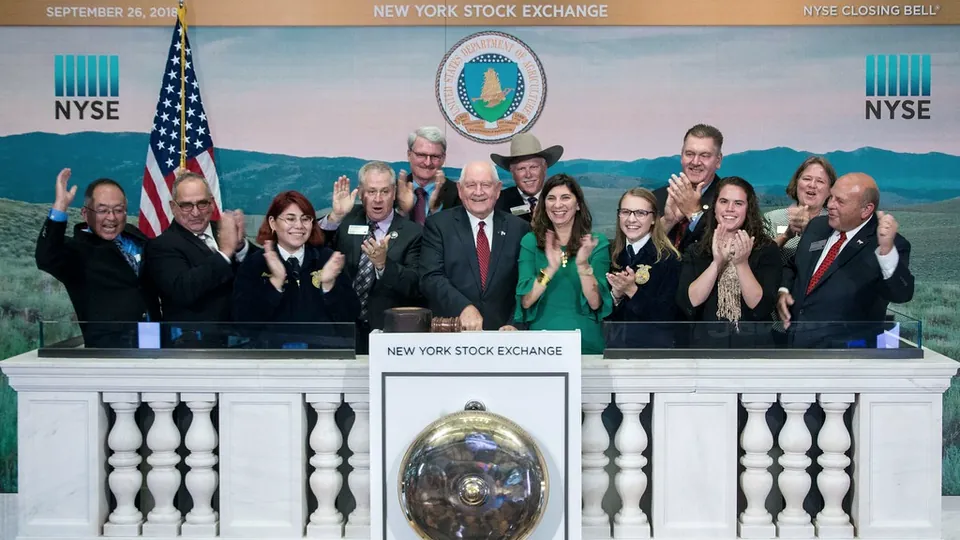 A group ringing the opening bell on the podium of the New York Stock Exchange