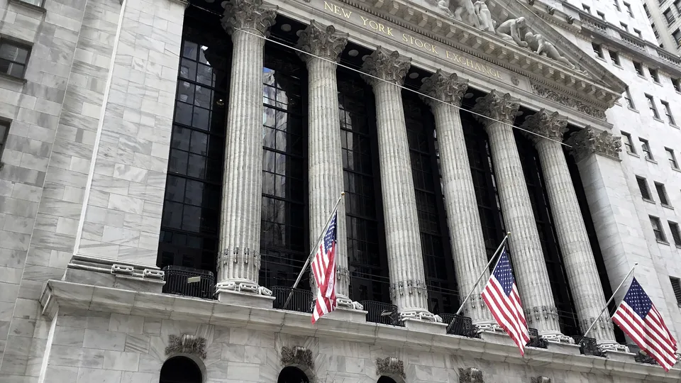 The columned facade of the New York Stock Exchange on Broad Street, hung with American flags